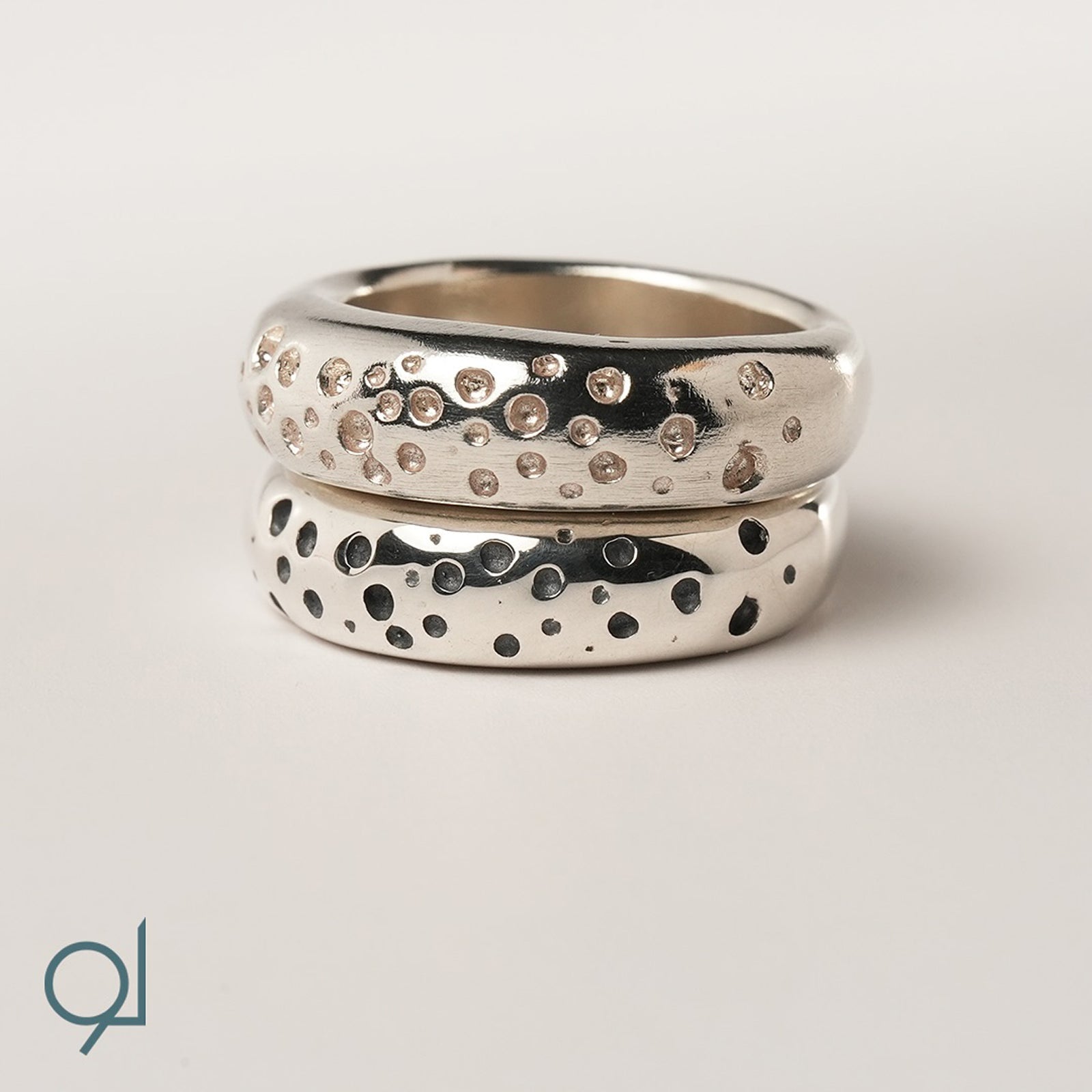 Two silver rings with textured designs and diamonds by Lamis Watfa